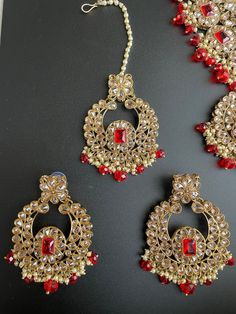 hyderabadi temple south light weight jadau bridal mehendi polki deep red Limited pieces available in 2 colors for this beautiful polki choker set that comes with matching tikka and jhumar/jhoomar. It is carved with polki stones and the finish is in antique gold with bronze tones. Modern and perfect for any event! Red Temple Jewelry Tikka With Cutdana, Red Kundan Tikka For Party, Elegant Red Kundan Tikka, Pink Elegant Kundan Tikka, Festive Pink Meenakari Choker, Ruby Necklace, Gold Choker, Indian Bridal, Deep Red