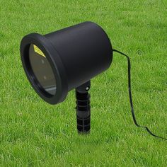 a black light sitting on top of a lush green field