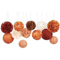 an assortment of decorative paper balls hanging from strings on a string with polka dotes