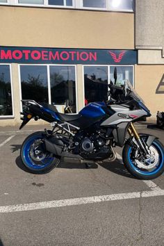 a blue motorcycle parked in front of a building