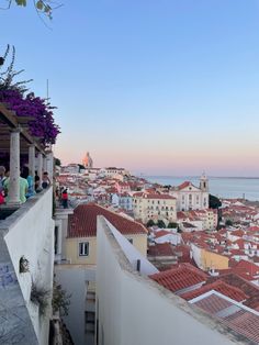 people are standing on the roof of an old building looking out at the city below