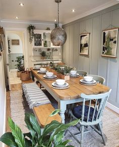 a dining room table and chairs with plates on them