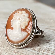 Antique Vistorian 800 Silver and Natural Carved Shell Cameo Ring Beautiful antique Victorian Cameo ring. It's 800 silver and natural hand carved shell cameo. Hallmarked on the band, great antique condition. Measurements  US: 6 UK: M Vintage Oval Carved Engraved Ring, Vintage White Gold Ring With Intaglio, Vintage White Gold Intaglio Ring, Vintage Silver Ring With Intaglio, Vintage Cameo Ring With Oval Cabochon, Vintage Silver Intaglio Rings, Vintage Cameo Oval Cabochon Rings, Vintage Cameo Rings For Collectors, Vintage Sterling Silver Intaglio Ring