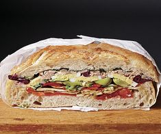 a large sandwich sitting on top of a wooden table