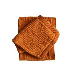 two orange knitted napkins sitting on top of each other