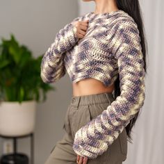 a woman with long hair wearing a crop top