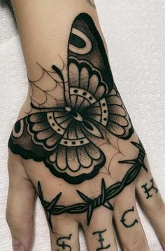 a woman's hand with a butterfly tattoo on it