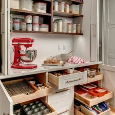 an organized kitchen with lots of drawers and items in the drawer area, including a mixer