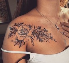 a woman's shoulder with flowers on it