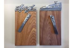 two pieces of wood with metal handles on each side, one has a knife and the other is a fork