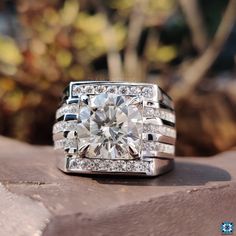 a diamond ring sitting on top of a rock