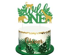 a green and gold jungle themed cake topper with the words wild one on it