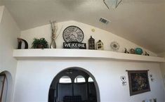 a living room filled with lots of furniture and decor on top of a white wall