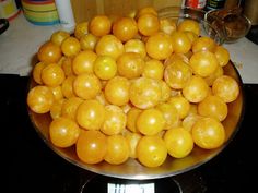 a bowl full of oranges sitting on top of a stove