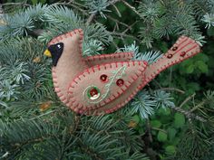 a pink bird ornament hanging from a tree