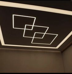 the ceiling is made up of square and rectangle shapes with white lights on them