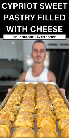 a man standing in front of a pan filled with pastries