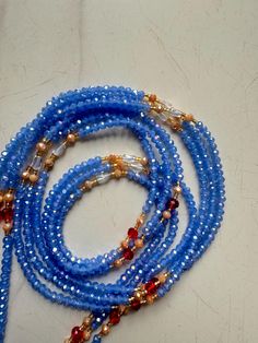 Please Note:Please scroll to see options. **These waist beads ship from Ghana, West Africa. They are traditional and authentic yet fancy and fashionable.* **Shipping takes 3-5 days to be delivered.* **I will send you nice selection of  Waist beads unless you want to make your own choices, then you can email me to send you individual pictures of the waist beads. #Waist bead length: 50 inches.  #They are all made with cotton threads #Bead sizes vary from 6/0, 8/0 12/0 All are in tie Ons Please feel free to message me if you have any questions. Thank You Blue Round Beads Waist Beads For Gift, Blue Waist Beads Gift, Elegant Faceted Waist Beads As Gift, Elegant Colorful Waist Beads For Gift, Blue Waist Beads With Spacer Beads As Gift, Blue Colorful Waist Beads As Gift, Elegant Handmade Waist Beads As Gift, Handmade Blue Waist Beads As Gift, Blue Beaded Waist Beads As Gift