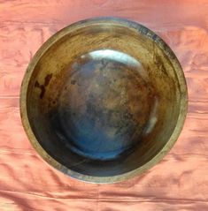 a wooden bowl sitting on top of a table