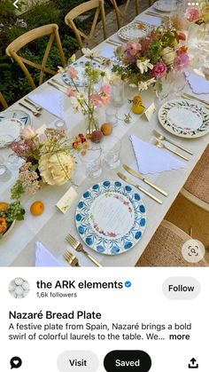 the table is set with flowers and plates