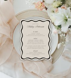 an elegant wedding menu is displayed on a plate