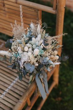 a bouquet of flowers sitting on top of a wooden chair