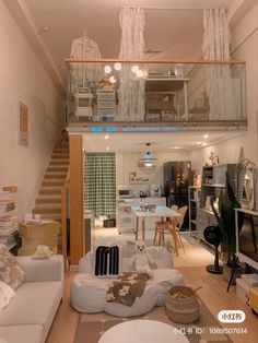 a living room filled with furniture next to a staircase