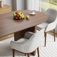 a bowl of fruit sitting on top of a wooden table next to two white chairs