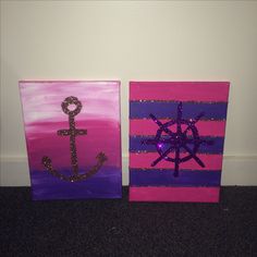 two painted canvass with an anchor and a wheel on the front one is purple