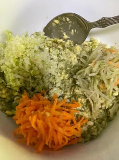 shredded carrots and broccoli in a bowl with a spoon