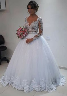 a woman in a white wedding dress holding a bouquet