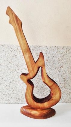 a wooden guitar sculpture sitting on top of a table