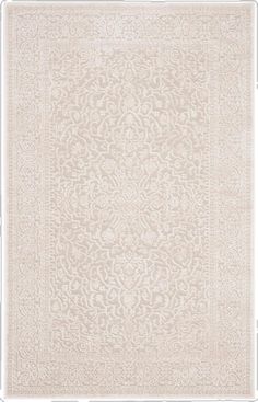 a white rug with an intricate design on the front and back side, in shades of beige