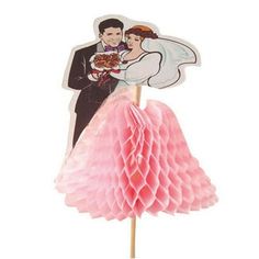 a cake topper with a bride and groom holding a cupcake on it's stick