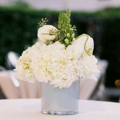 a vase filled with white flowers on top of a table