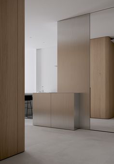 an empty room with wooden cabinets and white walls