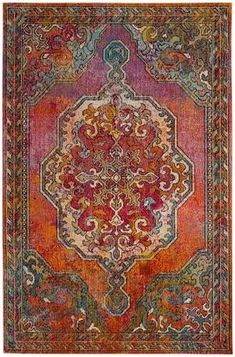 an orange, red and blue rug with ornate designs on the bottom half of it