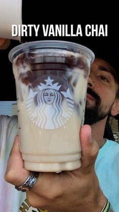 a man holding up a drink with the caption dirty vanilla chai