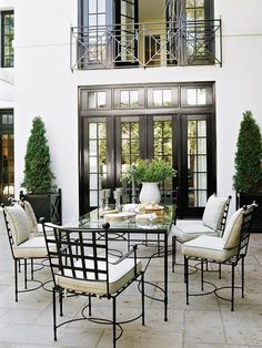 an outdoor living area with chairs and tables