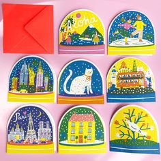 six magnets with different images of buildings and cats on them, one has an envelope in the middle