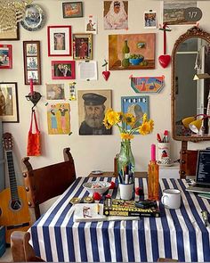 a dining room table covered in pictures and flowers