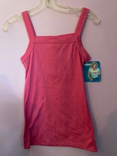 Vintage 1980's pink stretch knit (poly/cotton) tank top mage by Wrangler Juniors. Poly/cotton  Size Small, measurements are (unstretched, flat) 30" chest (up to 34-36) 24" top of shoulder to bottom hem. 90s Style Stretch Tank Top For Spring, Fitted Sleeveless 90s Tops, Pink Cotton Camisole Top, 90s Style Cotton Tank Top Vest, 90s Style Cotton Vest Tank Top, 90s Fitted Camisole Tops, 90s Fitted Vest Top, Pink Fitted 90s Style Tank Top, 90s Style Fitted Camisole Tops