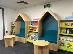 children's bookshelves and tables in an office setting with blue carpeting