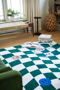 a living room filled with furniture and a checkered rug