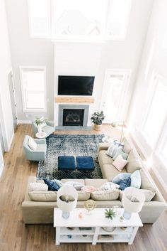 a living room filled with furniture and a fire place in the middle of the room