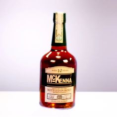 a bottle of mckenna is sitting on a table with its lid open and it's cap off