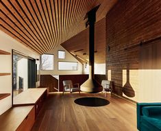 a living room filled with furniture and wooden floors next to a fire place in the middle of a room