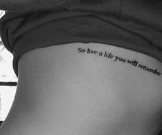 a woman with a tattoo on her stomach saying, so live a life you will remember