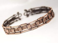 a close up of a bracelet on a white surface