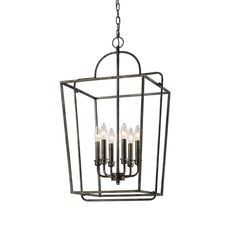 an iron cage chandelier with five candles hanging from it